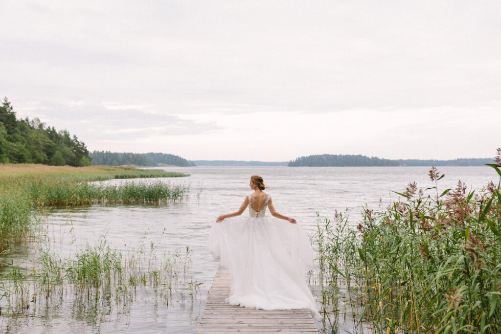Morsian ja hääpari merenrannalla omissa häissä laiturilla raaseporin saaristossa